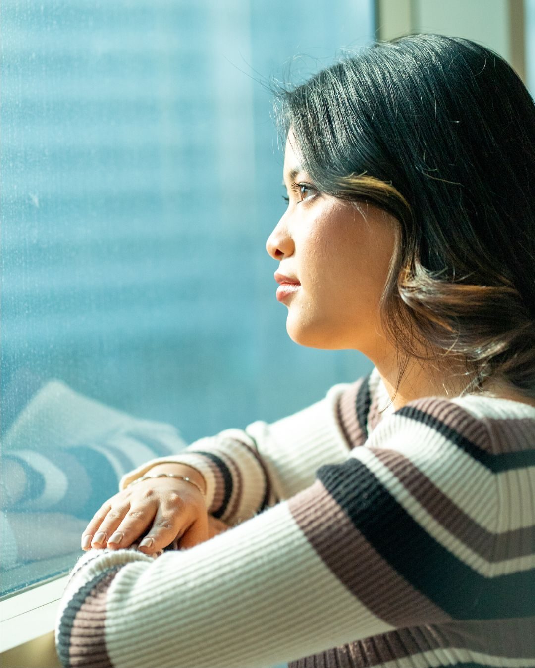 Sanabi Singha by a window